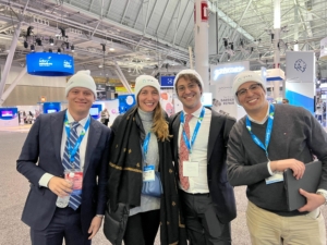 Four people posing for a photo at AAD 2022, a trade show.