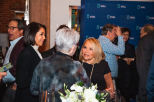 At the American Association of Dermatology (AAD) 2022 event, attendees engage in lively conversations with one another.