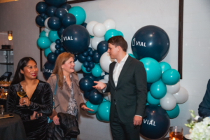 A group of people talking in front of balloons at the aad 2022 event.