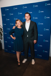 A man and woman posing for a photo in front of a blue wall at the aad 2022 event.