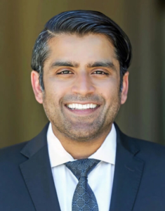 A smiling CRO executive in a suit and tie.