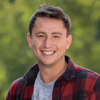 A smiling man in a plaid shirt at the ASRM 2022 conference.