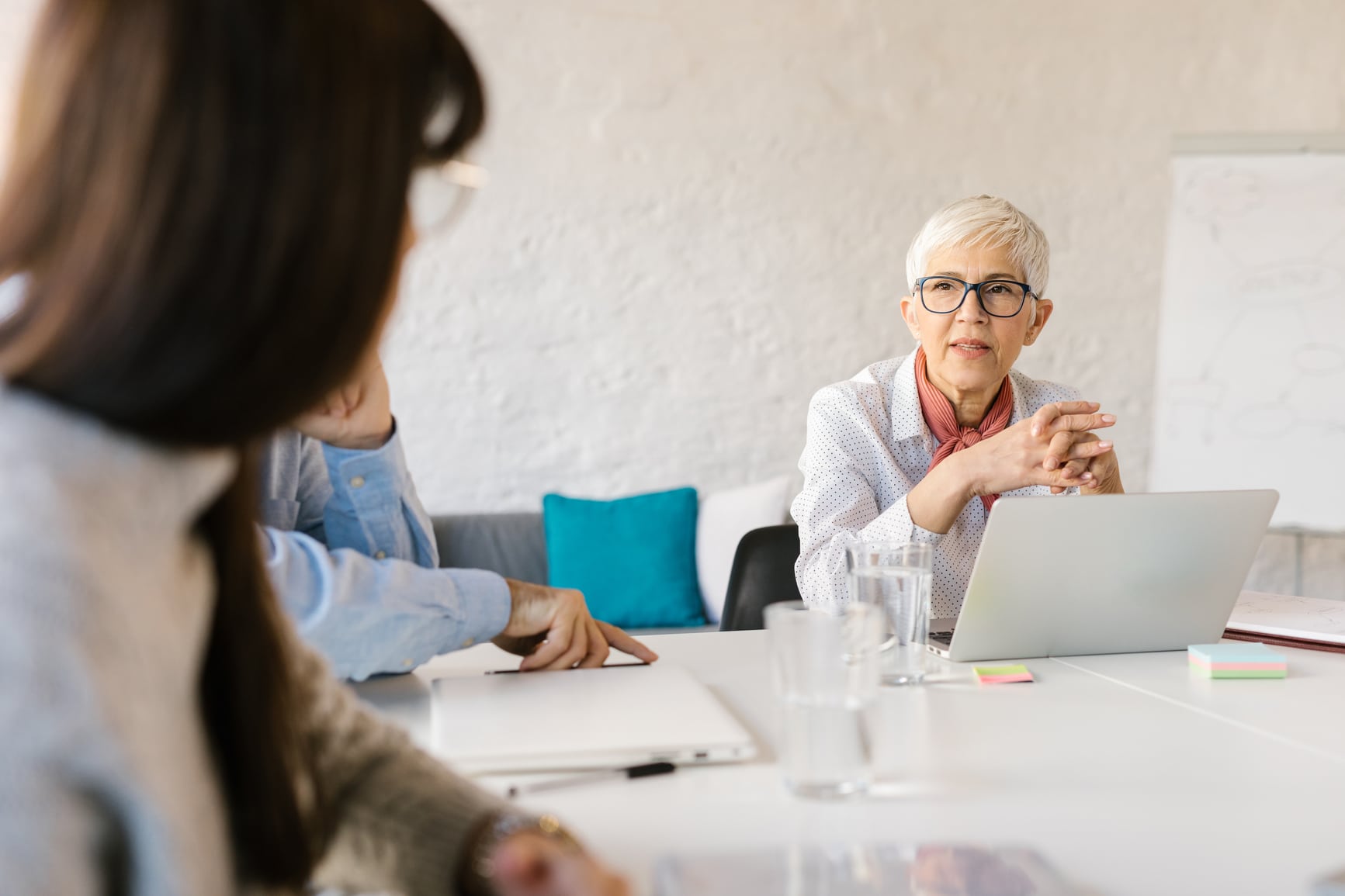 A group of sponsors sitting around a table in a meeting.