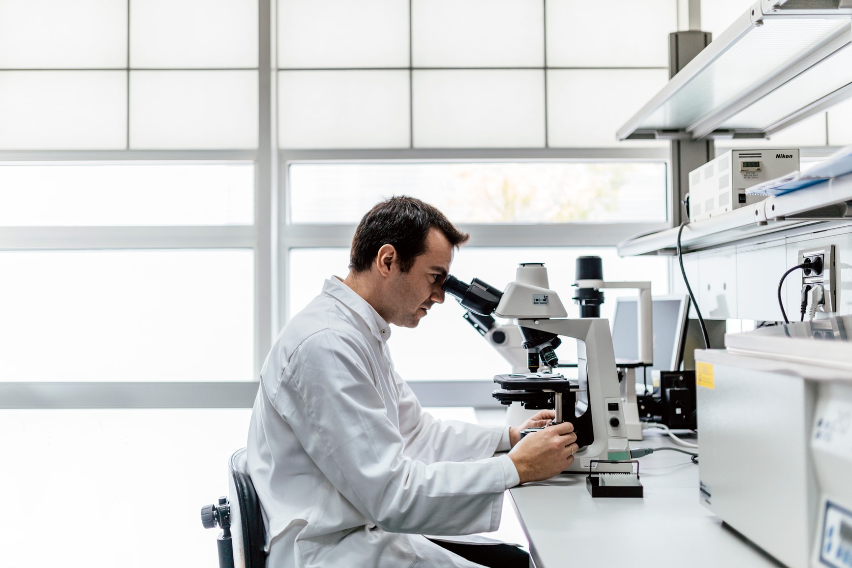 Oncology scientist sits in laboratory while conducting an oncology clinical trial