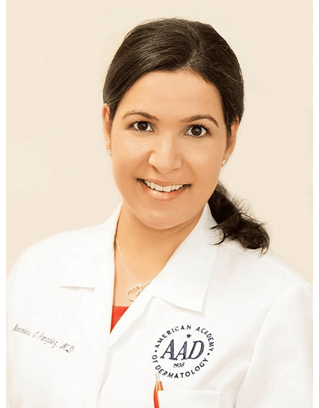 Dr. Mercedes Gonzalez, a woman in a white coat, smiling for the camera.