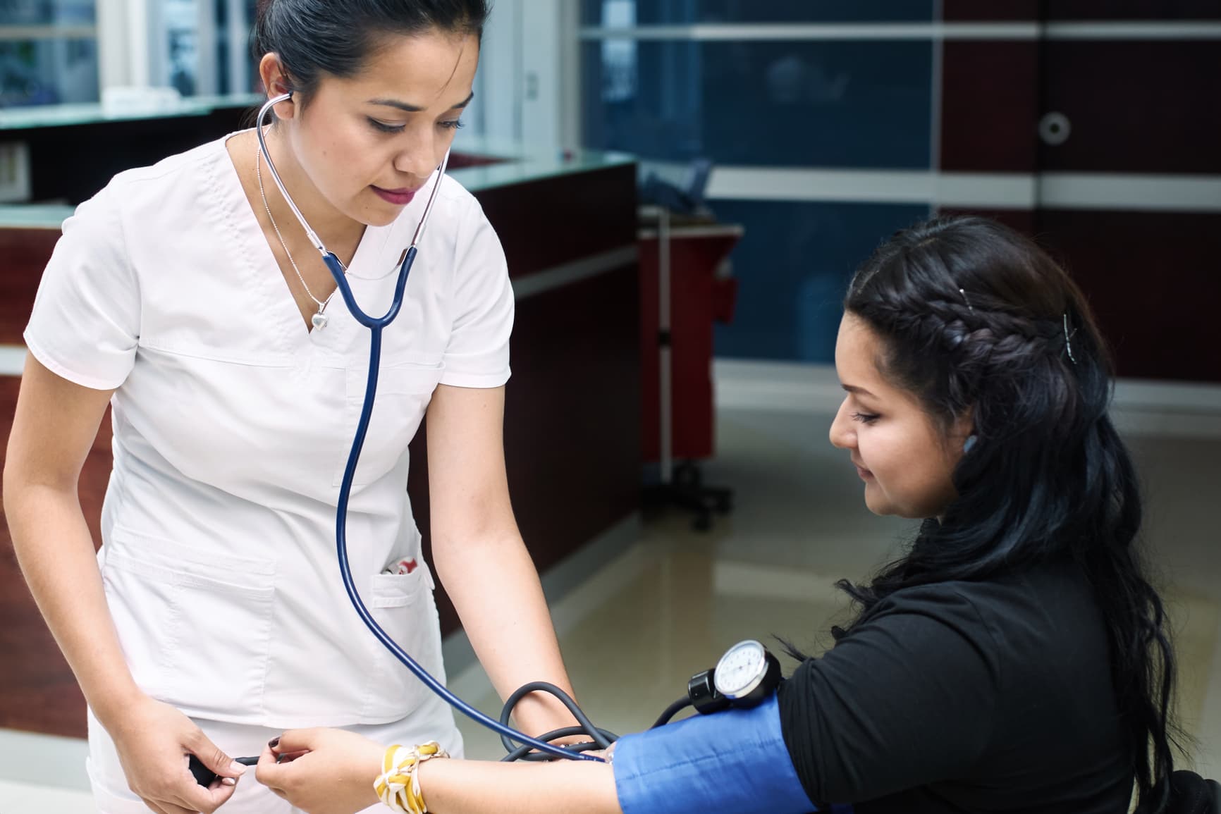 A nurse is performing a blood pressure check on a patient in a small cardiology clinic.