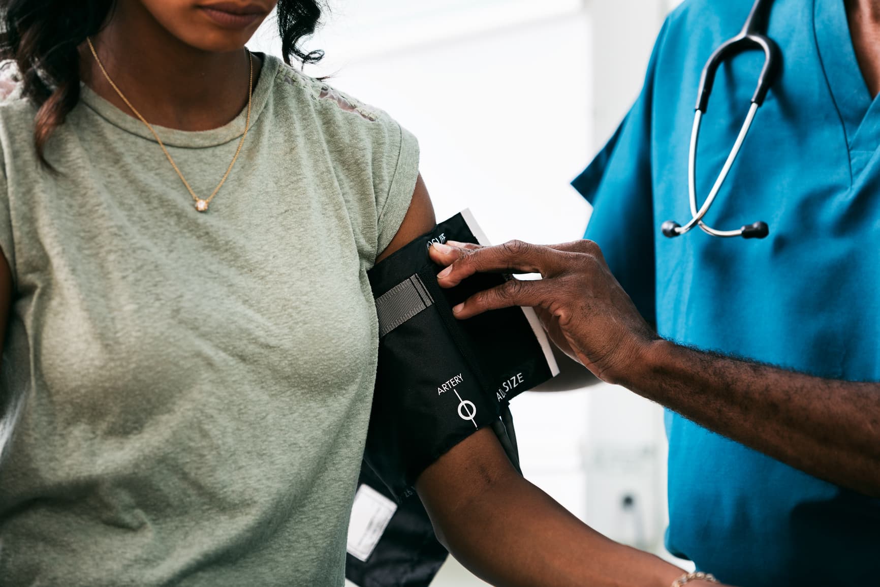 Male doctor measures blood pressure to assess a patient's cardiovascular health.