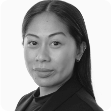 A black and white photo of a woman in a business suit attending the BIO International Convention.