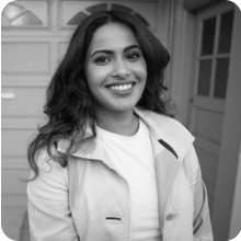 A black and white photo of a woman smiling.