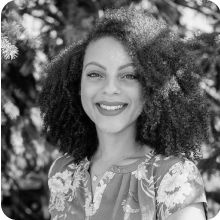 A black and white photo of a woman smiling at the ARVO 2023 conference.