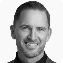 A black and white photo of a man smiling at the BIO International Convention.