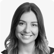 A black and white photo of a woman smiling.