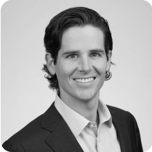 A black and white photo of a man in a suit attending the BIO International Convention.